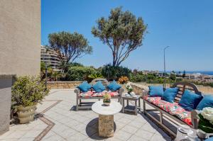 a patio with two couches and a table at Valleyside Heights Residence - Pool & Heated Jacuzzi in Is-Swieqi