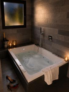 a large bath tub in a bathroom with candles at VILLA MIAMI in Les Issambres +45 photos