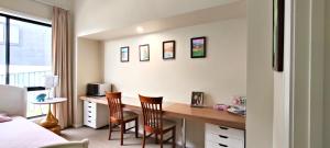 a bedroom with a desk and two chairs at A private room with lounge room in Unanderra