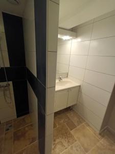 a white bathroom with a sink and a mirror at mahuet florent in Bissy-sous-Uxelles