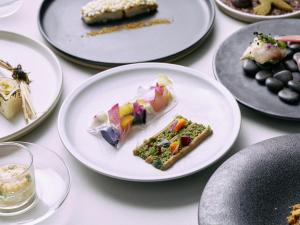 a table with plates of food on them at BIRD HOTEL in Kamakura