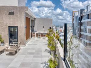 an apartment balcony with a view of a city at Torre Palmas Marcel in Ensanche Quisqueya