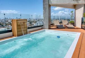 a swimming pool on the roof of a building at Torre Palmas Marcel in Ensanche Quisqueya