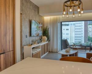 a dining room and living room with a dining table at Torre Palmas Marcel in Ensanche Quisqueya