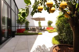 a courtyard with a lemon tree in a building at EST Hotel Palais Chotek NEW OPENING in Vienna
