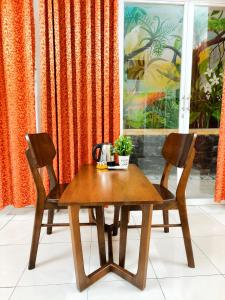a wooden table and two chairs in front of a window at QN Home in Quy Nhon +25 photos
