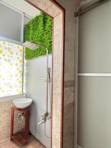 a bathroom with a sink and a shower at QN Home in Quy Nhon