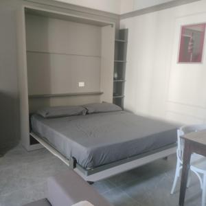 a bedroom with a bed and shelves in it at Il campanile in Corbetta