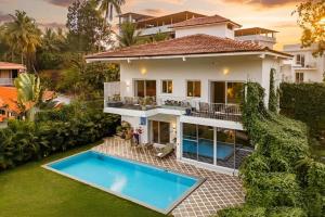 an image of a house with a swimming pool at Aroha Palms Luxury Villas in Mandrem