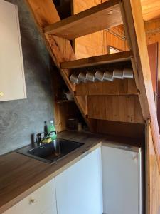 a kitchen with a sink and a wooden ceiling at Weekendica in Kopaonik +50 photos