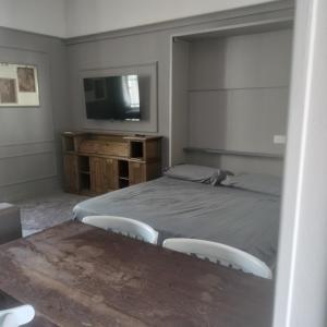 a bedroom with a bed and a flat screen tv at Il campanile in Corbetta