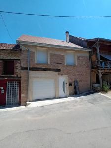 a brick house with a garage at mahuet florent in Bissy-sous-Uxelles