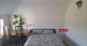 a bedroom with a bed and a table and a desk at The Green Yard - Ebike Available for Guests in Sundon