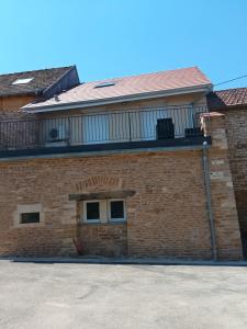 a brick building with a balcony on top of it at mahuet florent in Bissy-sous-Uxelles
