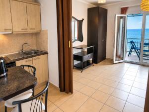 a kitchen with a table and a view of the ocean at Studios Plaka in Skala Kallirachis