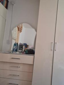 a room with a dresser and a mirror at Cozy Stay Emir in Kazarman +3 photos