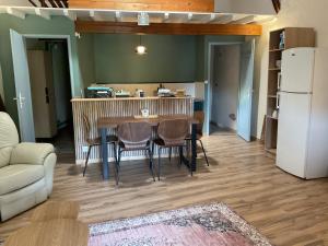 a kitchen and dining room with a table and chairs at Parenthèse clunysoise in Cluny