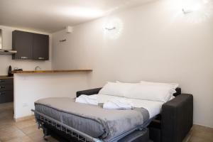 a bed with white pillows on it in a room at Humanitas - Leo Brothers - Leopardi 1 in Basiglio