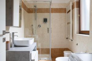 a bathroom with a shower and a sink and a toilet at Humanitas - Leo Brothers - Leopardi 1 in Basiglio +34 photos