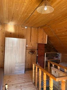 a room with a wooden ceiling and a refrigerator at Weekendica in Kopaonik