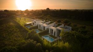 an aerial view of a house with the sun setting at Sevene Villas - Kourouta Peloponnese in Kourouta