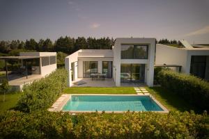 a house with a swimming pool in the yard at Sevene Villas - Kourouta Peloponnese in Kourouta