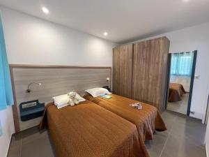 a bedroom with a bed with a teddy bear on it at Résidence Cantu di Mare in Olmeto