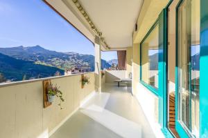 a balcony with a view of the mountains at Alpin Chic - Aare Jungfrau AG in Grindelwald