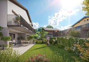a man standing in the yard of a house at Niesen Apartment - Aare Jungfrau AG in Spiez