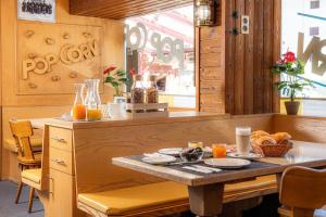 a table in a restaurant with orange juice on it at Hotel Haus am Wald in Arosa