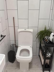 a bathroom with a white toilet and a sink at Hesketh Hideaway 1 in Marshside +2 photos