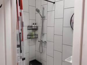 a shower in a white tiled bathroom at Hesketh Hideaway 1 in Marshside