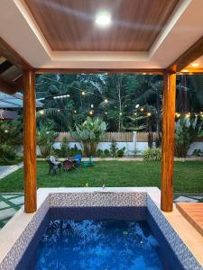 a swimming pool in the middle of a house at Villa de Miguel in Migit