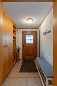 a hallway with a door and a bench in a room at Apartment Chalet Condor - Aare Jungfrau AG in Grindelwald +16 photos