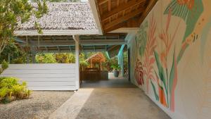 an entrance to a house with a painting on the wall at La Rana De Cahuita in Cahuita +48 photos