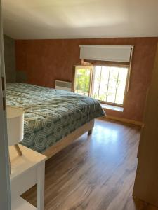 a bedroom with a bed and a window at Parenthèse clunysoise in Cluny +5 photos