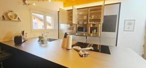 a kitchen with a counter top in a kitchen at Jungfrau Penthouse - Aare Jungfrau AG in Wilderswil