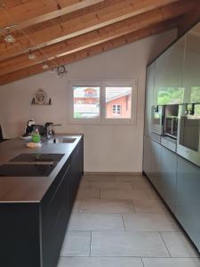 a kitchen with a sink and a counter at Jungfrau Penthouse - Aare Jungfrau AG in Wilderswil +59 photos