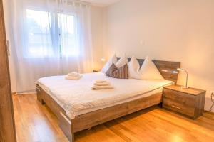 a bedroom with a bed with towels on it at Harder Apartment - Aare Jungfrau AG in Wilderswil