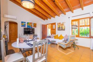 a dining room and living room with a table and chairs at Can Gallu - Adults Only. in Moscari