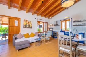 a living room with a couch and a table at Can Gallu - Adults Only. in Moscari