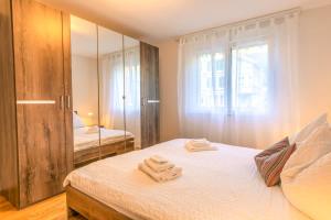 a bedroom with a bed with towels on it at Schilthorn Apartment - Aare Jungfrau AG in Wilderswil