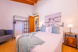 a bedroom with a white bed and a couch at Can Gallu - Adults Only. in Moscari +15 photos