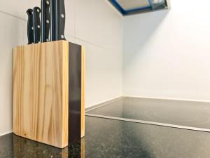 a knife block filled with knives on top of a counter at Nika Apartment - Aare Jungfrau AG in Grindelwald