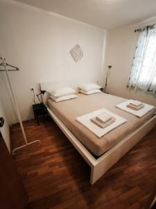 a bedroom with a bed with two pillows on it at Istrian old town apartment in Koper +30 photos