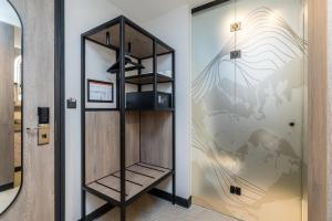 a room with a wall with a glass door at Alpine Hotel by SnowWorld in Landgraaf +45 photos