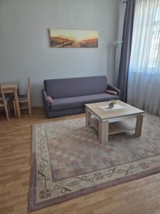 a living room with a couch and a coffee table at Baltic Plaza Gdynia - MAXIMAL in Gdynia