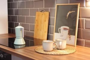 a counter with coffee cups and pictures on it at Finca Rivari in Tinajo
