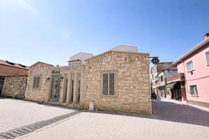 a stone building on a street in a city at Studio Miscela in Urla
