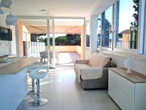 a living room with a couch and a table at SIT Holiday Homes in Lido delle Nazioni